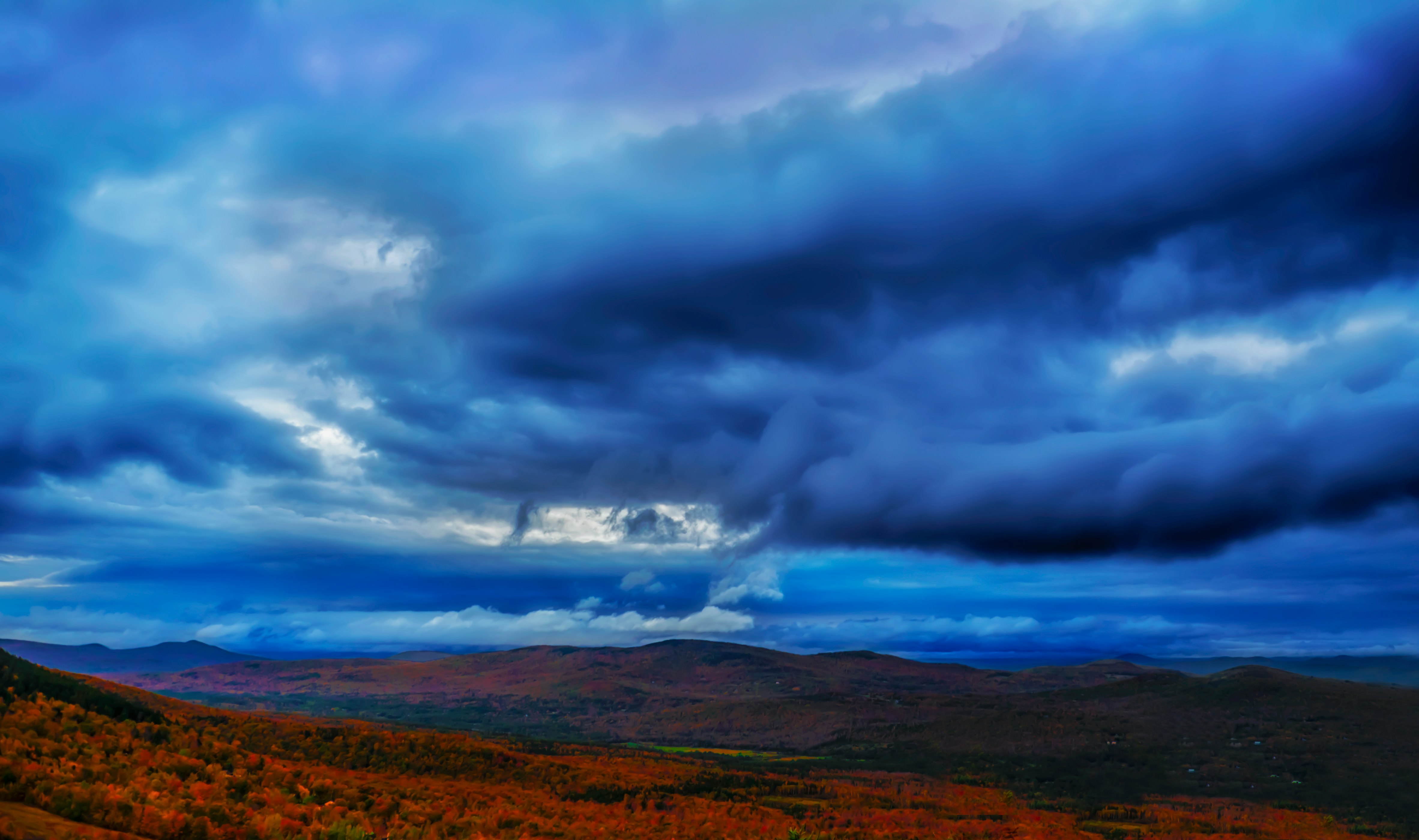 brown field under gray clouds